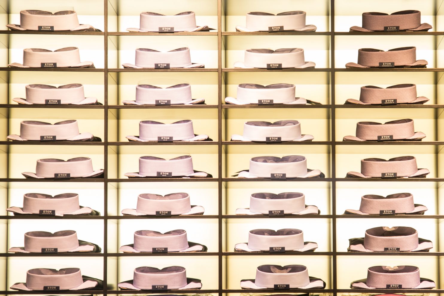 Collared shirts folded on shelves.