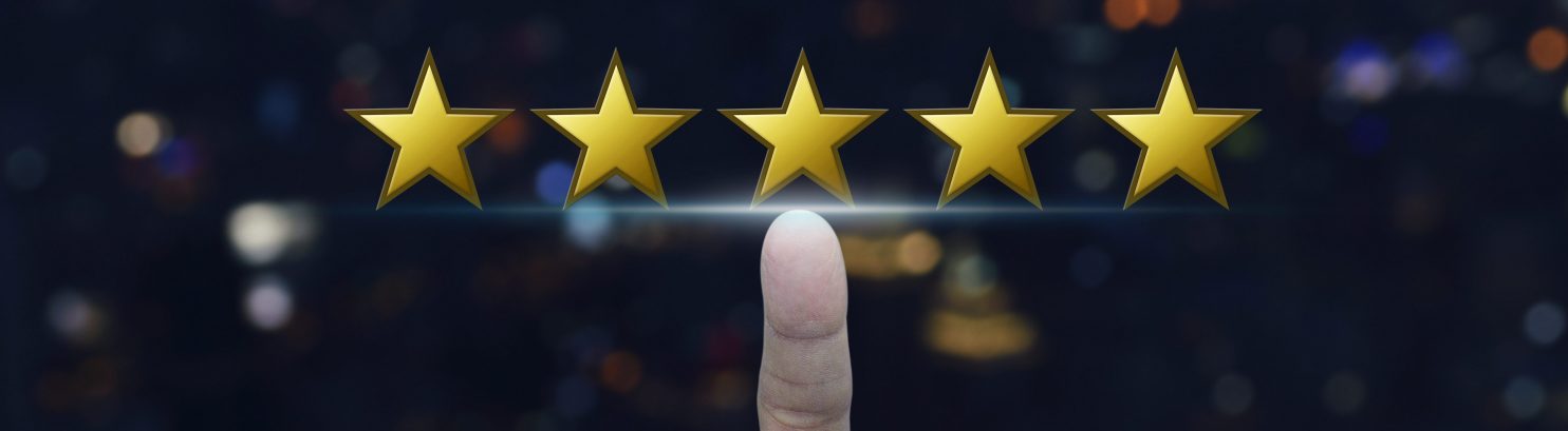 5 gold stars with a pointer finger pointing at the middle star.