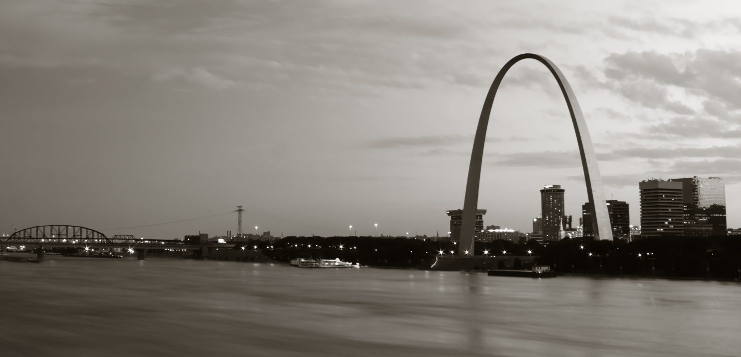 Photo of downtown St. Louis, Missouri. Includes the Mississippi river and the Gateway Arch.