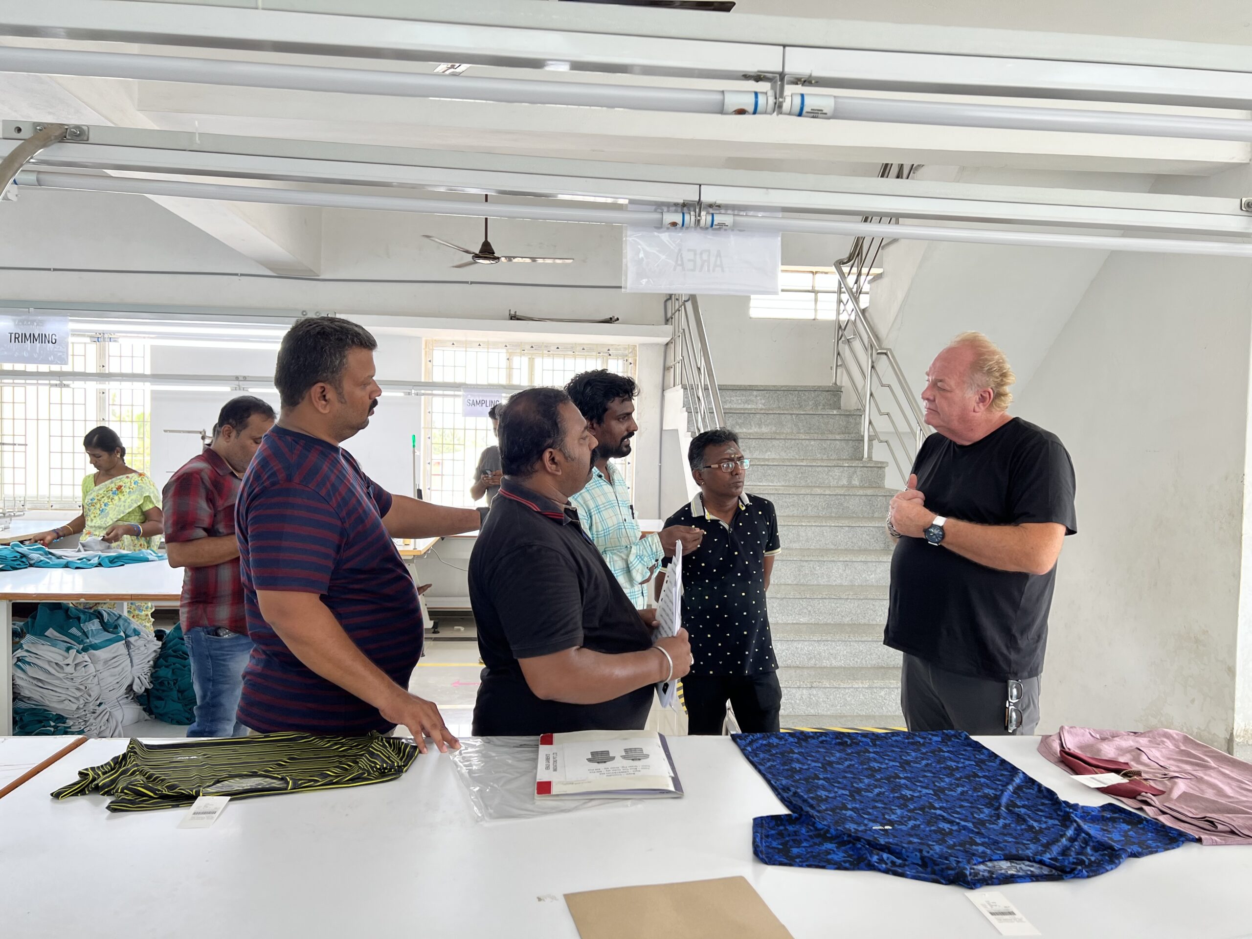 Image of Bret Schnitker talking to factory partners in India